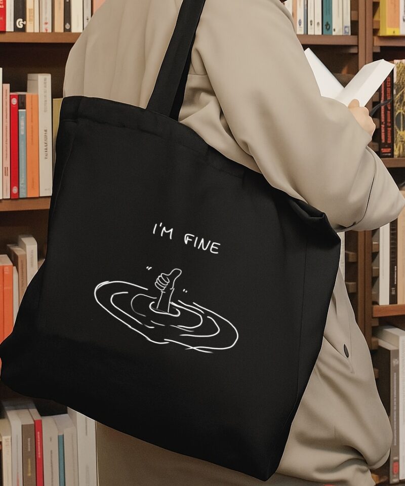 Black cotton tote bag with “I’m Fine” text and hand reaching from water