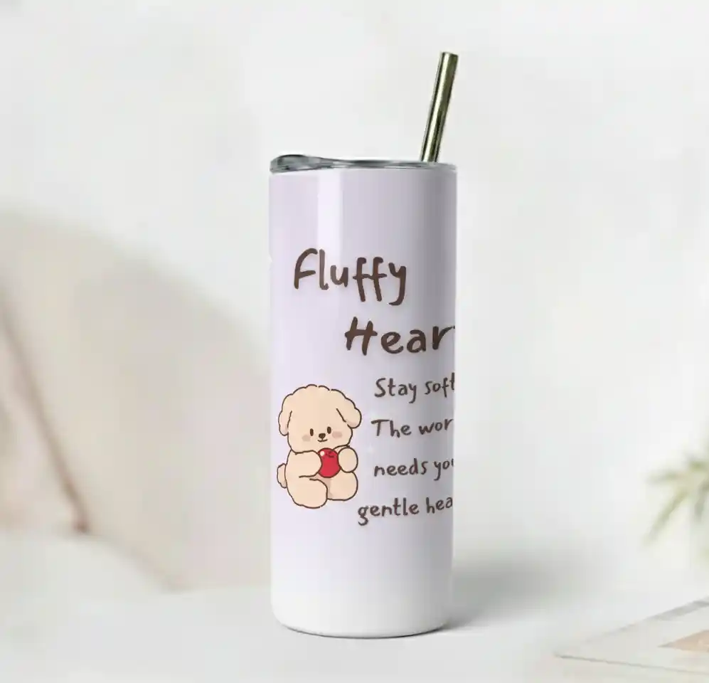 Fluffy Heart Tumbler with a cute cartoon dog holding a red heart on a pale lavender glossy surface with uplifting quote