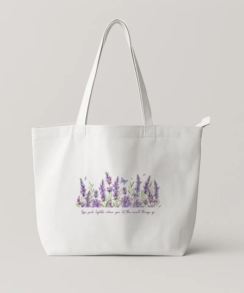 White or black tote bag featuring a watercolor lavender illustration with a gentle inspirational quote.