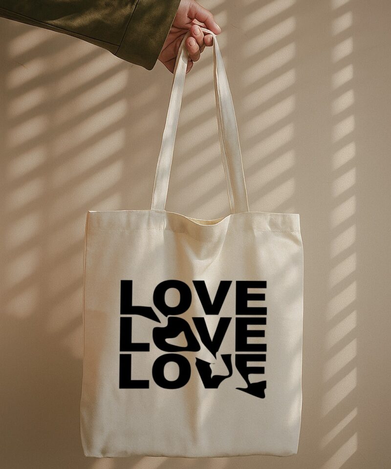 Tote bag with the word “LOVE” repeated three times, featuring a heart shape formed by negative space in the center.