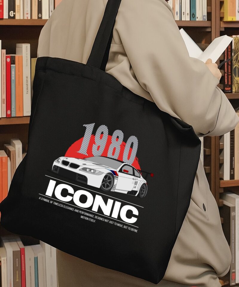 Black tote bag featuring a white race car with red and blue details, large “1980” text above, and “ICONIC” below.