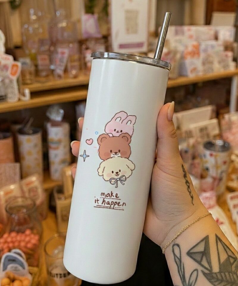 White tumbler with stacked bunny, bear, and dog illustration with “make it happen” text