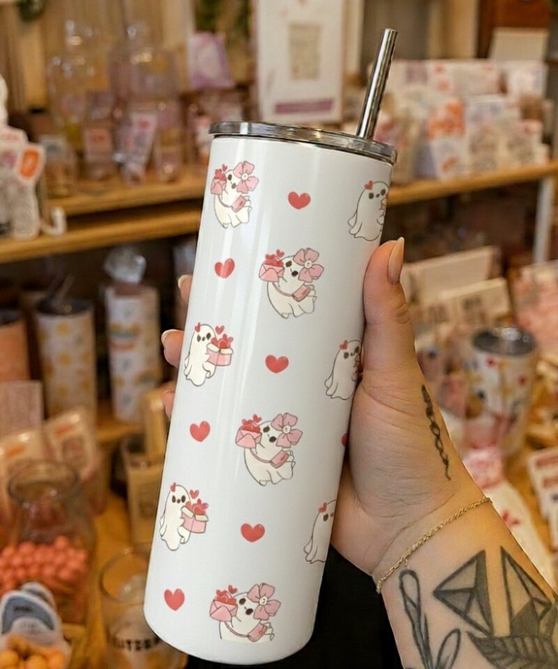 White tumbler with repeating Valentine ghost pattern holding hearts and gifts