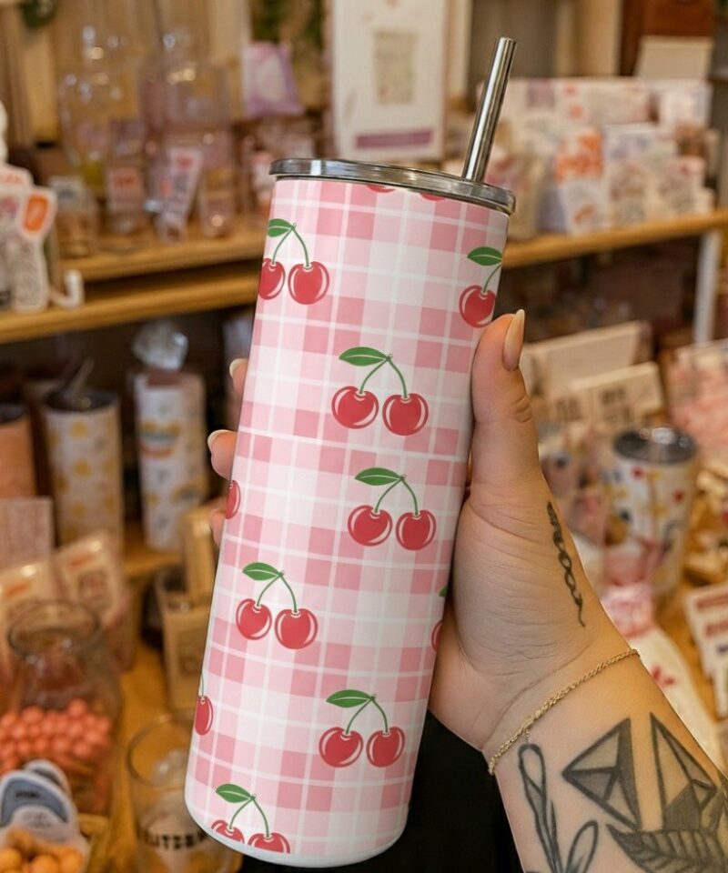Pink gingham tumbler with repeating red cherry pattern